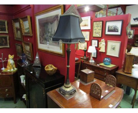 A classical table lamp base with tasselled shade 
