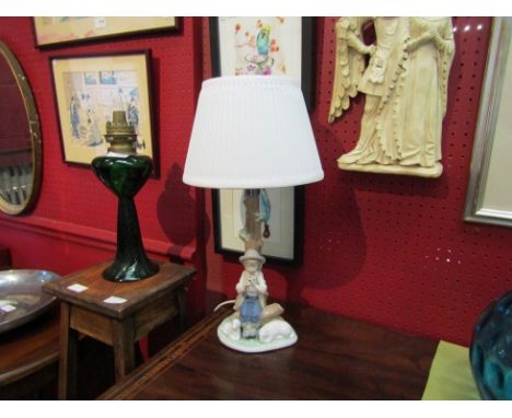 A Nao table lamp with a figural group of a boy playing a piccolo with a sheep and lamb to his side 