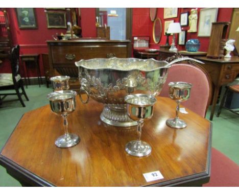 A silver on copper punch bowl with floral swags and lion mask ring handles, a matched ladle and a set of six silver plated go