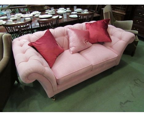 A modern pink button back scroll arm cottage sofa with loose seat cushions and three decorative cushions 