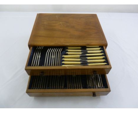 A cased canteen of silver plated flatware for eight persons to include knives, forks, spoons and carvers