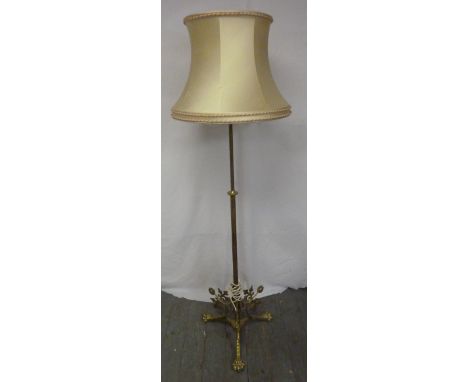 An Art Nouveau style brass standard lamp with silk shade