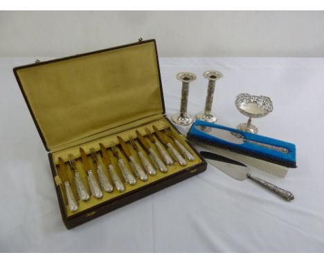 A quantity of silver and white metal to include a pair of candlesticks, a bonbon dish and flatware