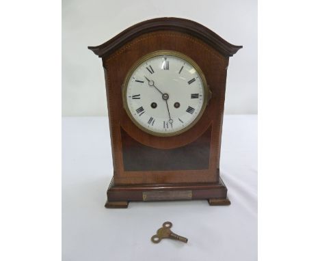 An Edwardian bracket clock, arched top, enamel dial with Roman numerals, two train movement to include key
