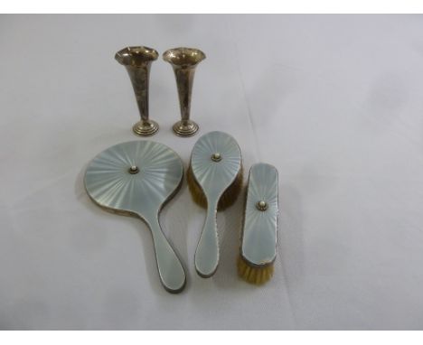 A silver and enamel three piece dressing table set and a pair of silver bud vases