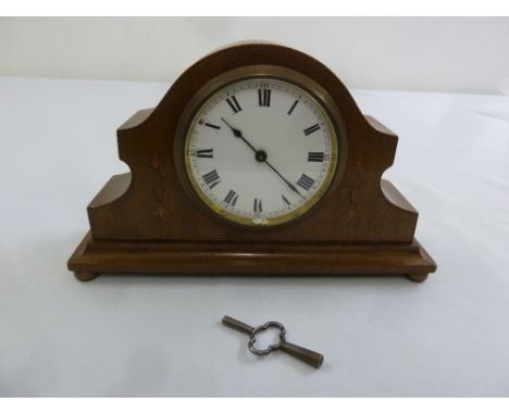 An Edwardian mantle clock of customary form, enamel dial with Roman numerals to include key