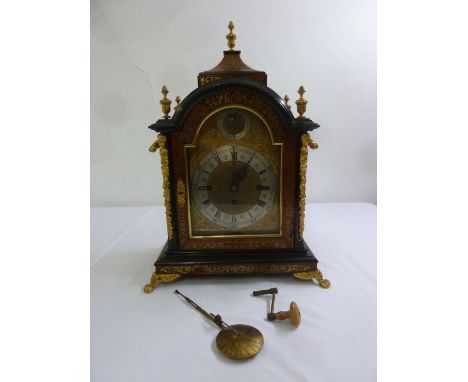 A late 19th century English Boulle chiming bracket clock, the arched top supporting vase form finials, the silvered chapter r