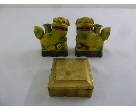 A pair of Oriental yellow glazed ceramic Dogs of Foe and a gold lacquered box