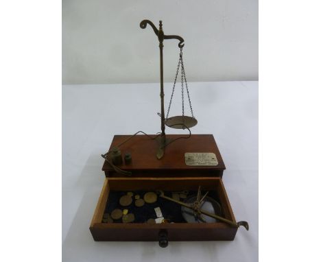 A cased set of mahogany and brass jewellery balance scales and weights