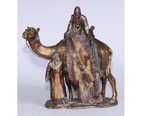 An early 20th century Austrian cold painted metal table lighter, cast in the Orientalist taste as an Arab carpet seller, his 