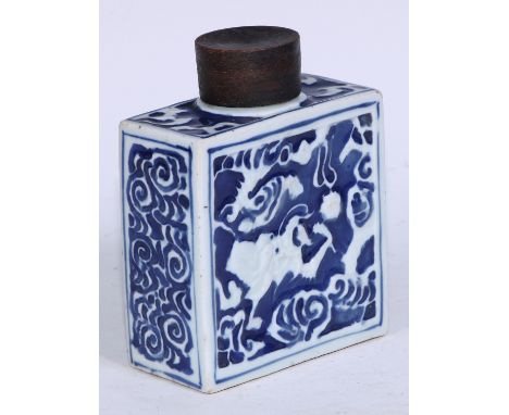 A Chinese porcelain rectangular tea caddy, moulded and painted in tones of underglaze blue with stylised dragons, 15.5cm high