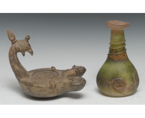 A Grand Tour type terracotta oil lamp, after the ancient Roman, avian mask cresting, 20cm long; a glass bottle, applied with 