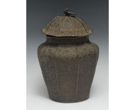 A 19th century Indian bronze vase and cover, cast in relief with lotus, peacock finial, 28cm high, 19th century 