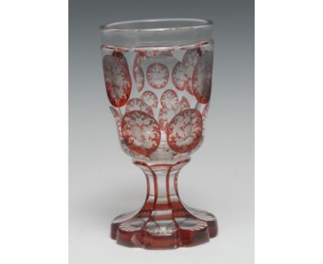 A Bohemian ruby overlaid glass spa goblet, etched with reserves of flowers and foliage, shaped circular base, 15.5cm high, c.