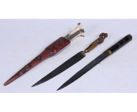 An Indian/Middle Eastern dagger, 18.5cm straight single-edged blade, the brass mounted horn hilt carved as a bird and inlaid 