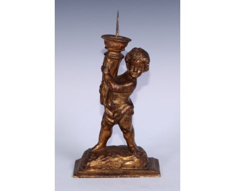 A Baroque design giltwood and gesso figural pricket candlestick, carved as a putto holding a cornucopia, rectangular base, 36