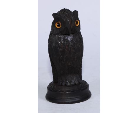 A 19th century Irish bog oak novelty inkwell, carved as an owl, glass eyes, circular base, 12cm high, c.1880 