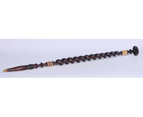 An unusual 19th century spirally turned walking stick, the engine turned pommel set with an Austrian silver coin, 84cm long 