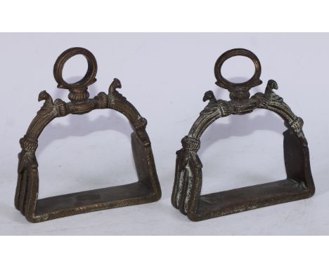 A pair of Mughal Indian bronze stirrups, cast in the Islamic taste with birds and chased with stiff leaves and flowerheads, 1
