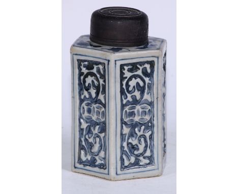 A Chinese porcelain hexagonal tea caddy, moulded and painted in tones of underglaze blue with leaves and scrolls, 15.5cm high