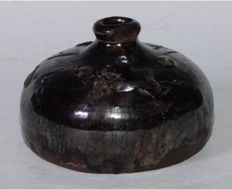 An 18th century lustre slip glazed earthenware compressed onion shaped inkwell, 11.5cm diam, incised W.S and dated 1733 