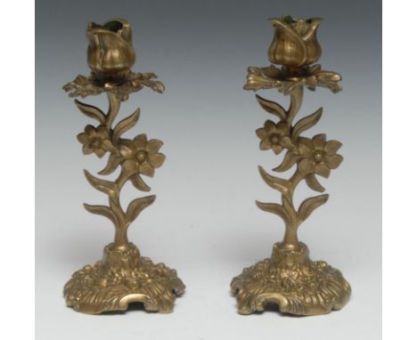A pair of post-Regency gilt bronze candlesticks, cast with flowering stems and acathus, 20cm high, c.1830 