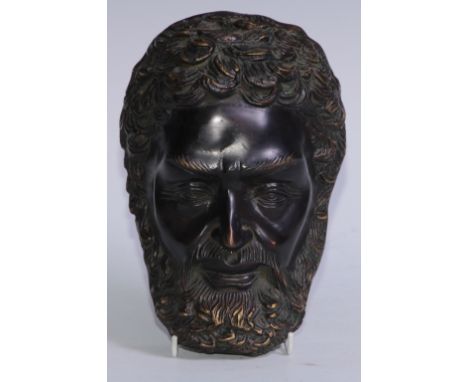 After the Antique, a dark patinated bronze mask, cast in the Grand Tour taste as the face of a bearded man, 22.5cm long 