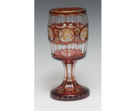 A Bohemian ruby overlaid glass spa goblet, decorated in enamel with reserves of flowers and leafy C-scrolls, 17cm high, c.190