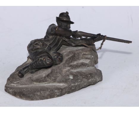 Continental School (early 20th century), a dark patinated bronze, of a World War I Italian soldier, taking aim, rocky base, 1