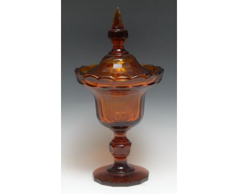 A large Bohemian amber glass faceted pedestal goblet and cover, knop and spire finial, 42cm high, c.1900 
