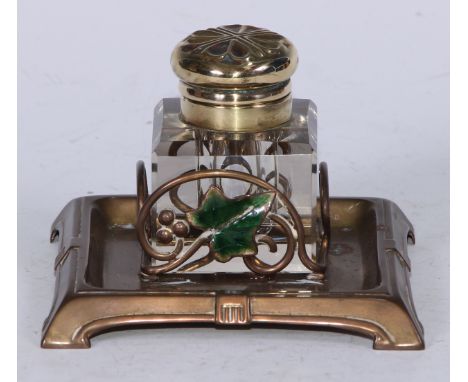 An Art Nouveau brass and enamel square inkstand, decorated with an ivy leaf, the glass well with hinged cover, outswept brack