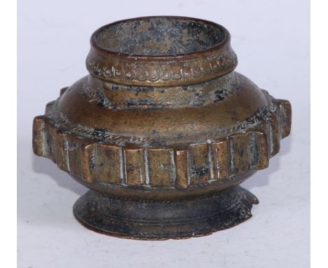 An Islamic bronze vessel, the side with a band of geometric lugs, spreading foot, 10cm diam, 19th century or earlier 
