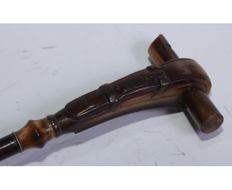 A 19th century walking stick, the horn handle as a buckle and whistle, polished hardwood cane, 80cm long 