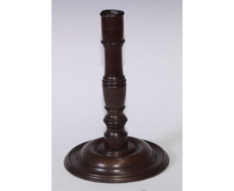 Treen - a re-purposed mahogany candlestick, turned pillar and base, 27cm high, the timber c.1820 