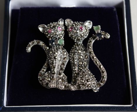 A SILVER MARCASITE RUBY ENAMEL AND SAPPHIRE DOUBLE CAT BROOCH