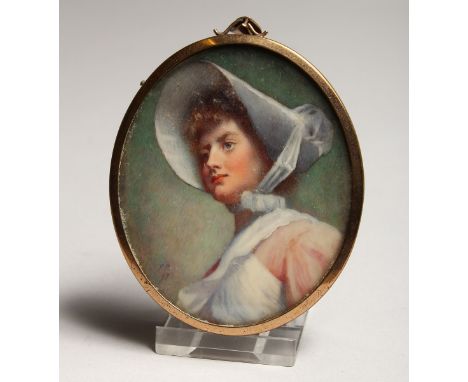 AN OVAL PORTRAIT MINIATURE OF A LADY wearing a bonnet 3ins x 2.5ins