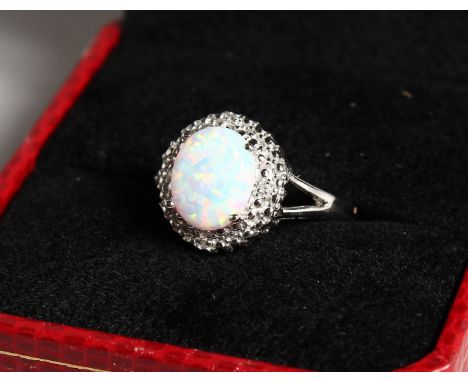 AN OPAL AND DIAMOND CLUSTER RING