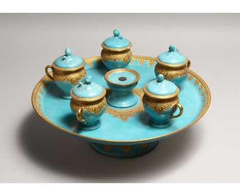 A CONTINENTAL LIGHT BLUE PORCELAIN CIRCULAR TURKISH - ISLAMIC DRINKS SET with gilt decoration, comprising comport, five cups 