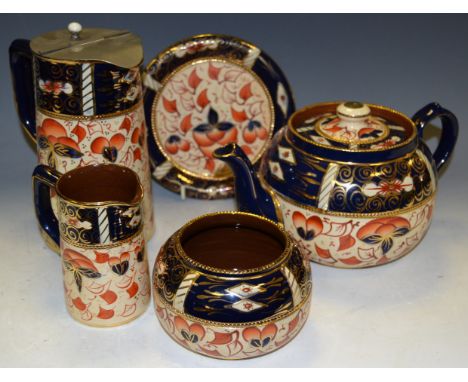 A 'Gaudy Welsh' four part tea service consisting of teapot and stand, hot water jug, sugar bowl, milk jug 