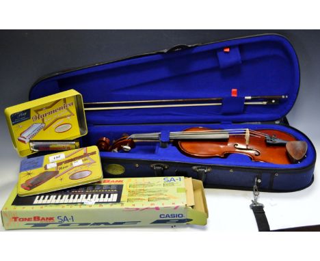 A Stentor child's violin with bow, cased; a Casio SA-1 Tone Bank Keyboard; a Robert Frederick Learn to Play Harmonica in orig