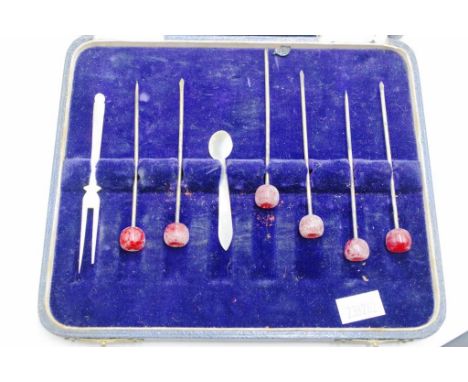 Cased set six decorated cocktail sticks each cocktail stick with beaded decorated finial; together with a Mother of Pearl coc