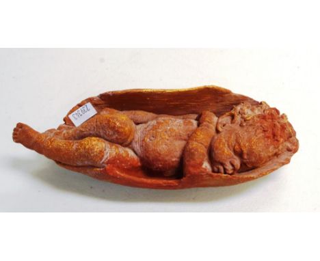 Peter Sedcole Aboriginal child figure sleeping child in tree bark, marks to base, 22cm length approx.