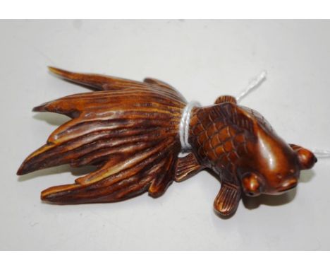Japanese carved boxwood fighting fish netsuke signature to base, 7.5cm length approx