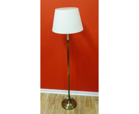 A brass fluted standard lamp complete with shade