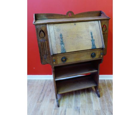 An Art Nouveau oak students bureau with a fall front enclosing fitted interior above a freize drawer and two shelves, 92 x 12