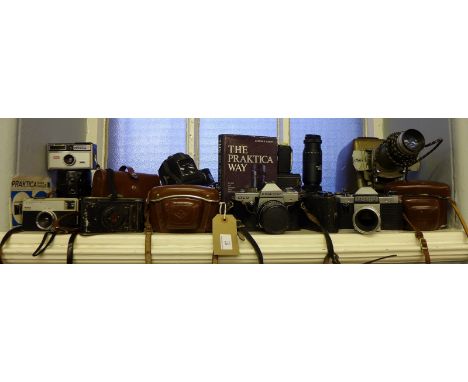 A large collection of vintage cameras to include Praktica and Kodak together with a reference book and various camera lens an