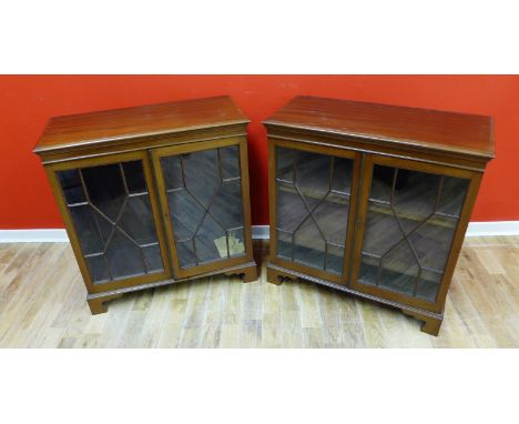 A pair of mahogany bookcases with astragal glazed panel doors enclosing adjustable shelves and raised on bracket feet, 83 x 8
