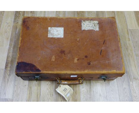 A vintage brown leather suitcase, stamped with initials N.R, 66cm wide