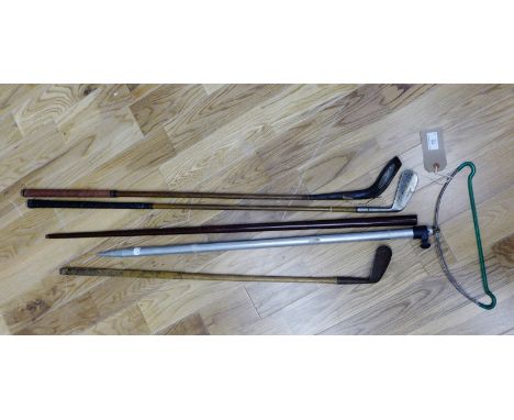 Three vintage golf clubs and a fishing rod holder, and a cane etc (5)