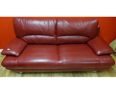 A contemporary red leather two  seater sofa on chromed supports 